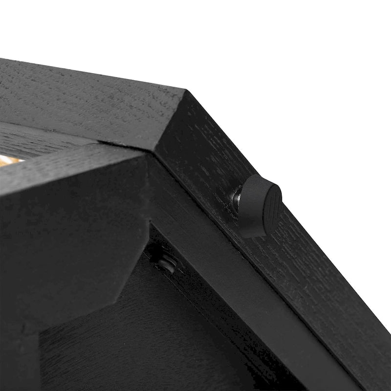 Console étroite noire en forme de flèche avec panneaux en rotin tressé